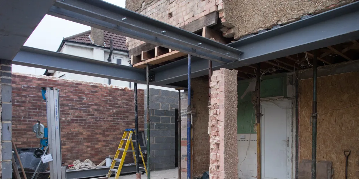 Beam welding specialist in London measuring and preparing a steel beam